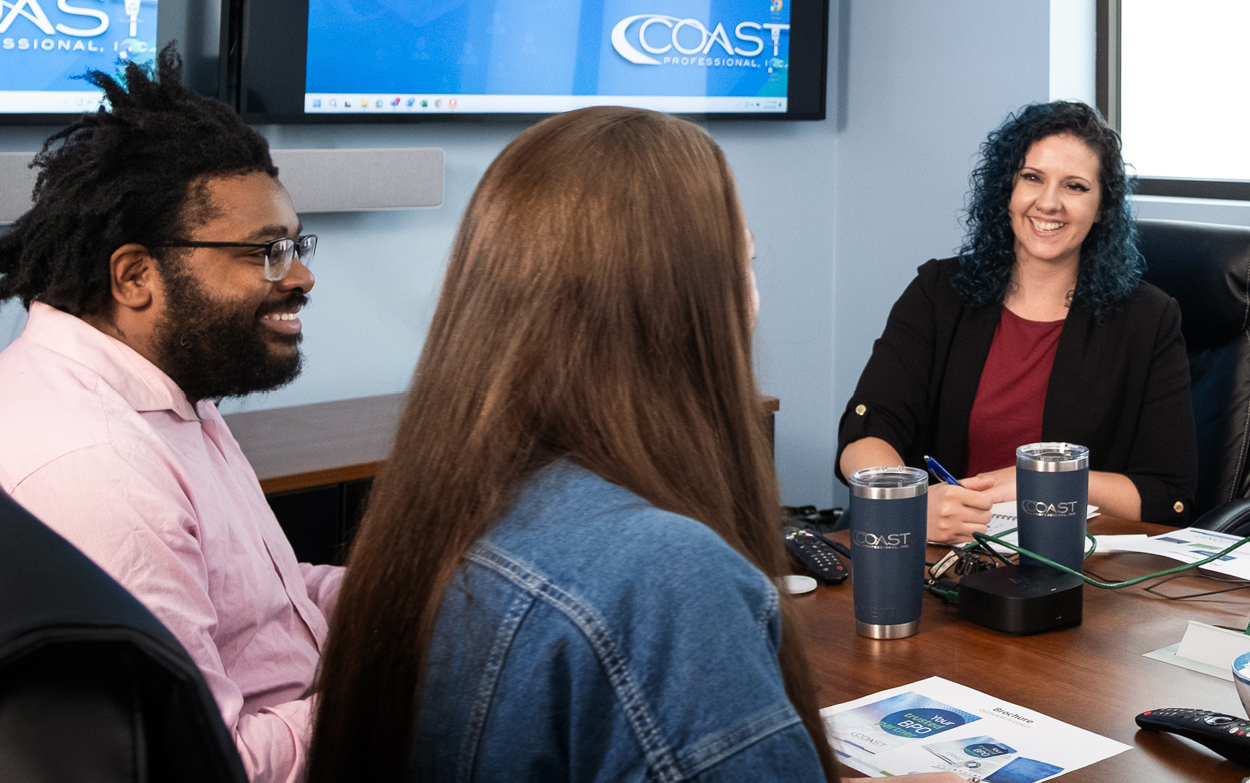 Three people sitting at table