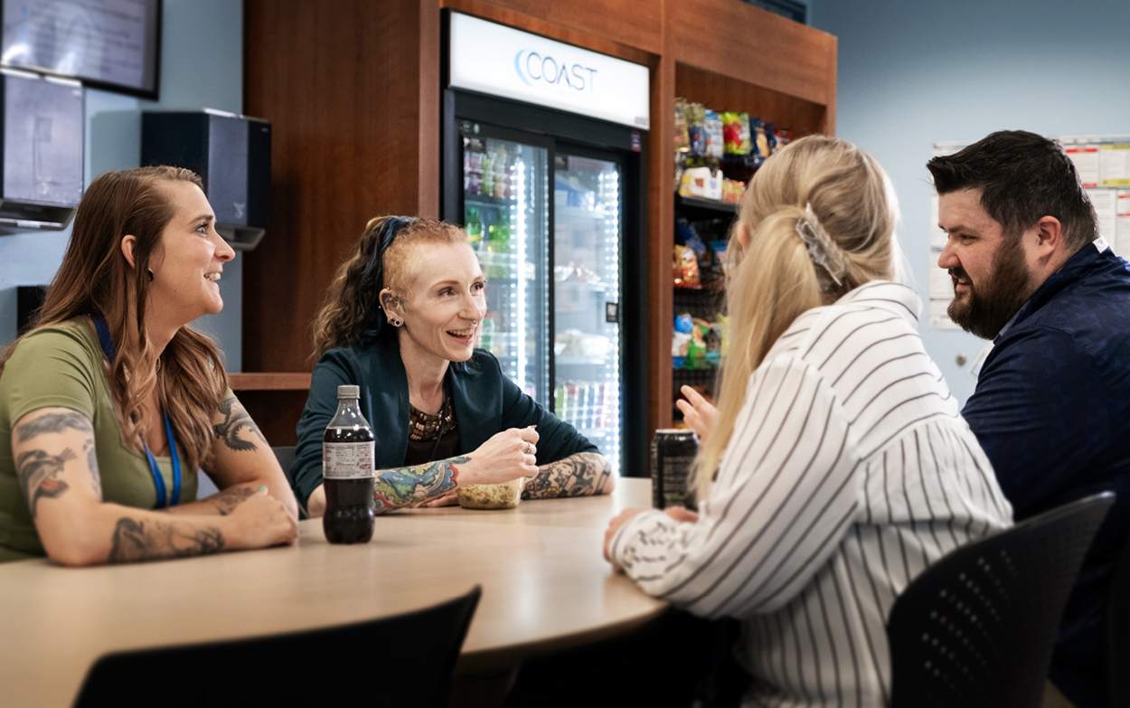 four friends in breakroom
