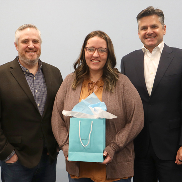 Employee receives recognition gift from leadership