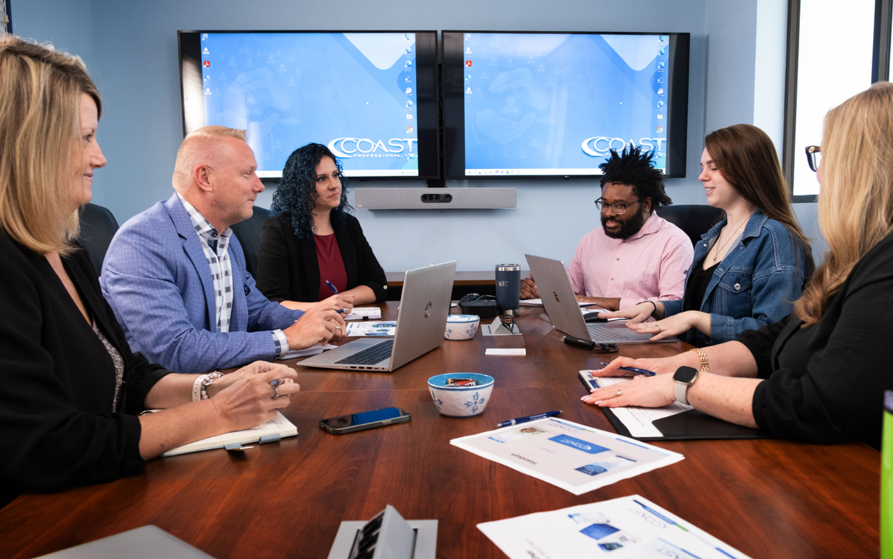 Six team members at a board table